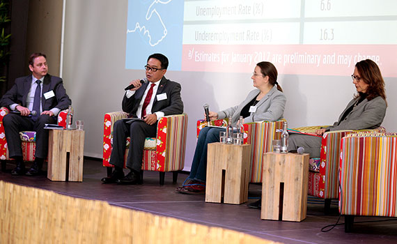 female and male speaker on the podium