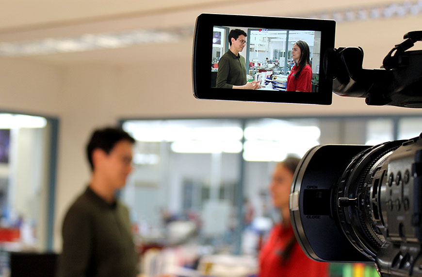 two persons talking - seen through the camera