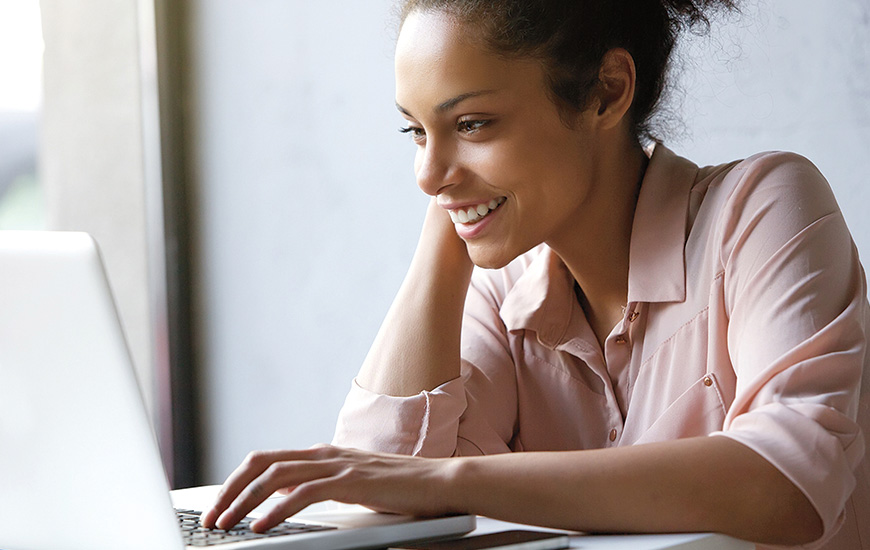 African woman works on laptop