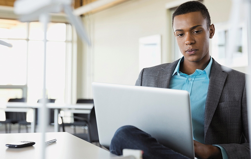 African man works on laptop