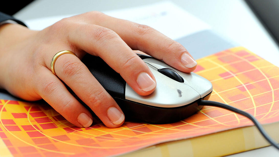 hand on computer mouse