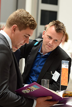 persons leafing through a brochure
