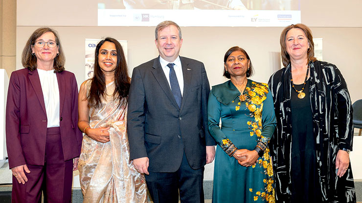 Group photo with four women and one man in the middle