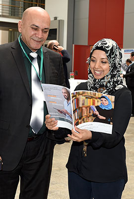 Persons leafing through a brochure