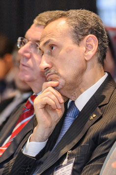 Close-up of two men listening to a speaker