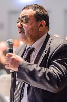 listener standing with a microphone in his hand