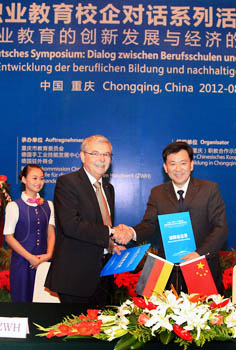 Shaking hands at the signing of the memorandum of understanding