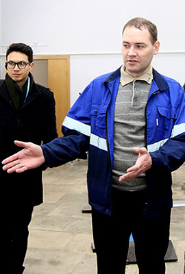 Person in work clothing explains something