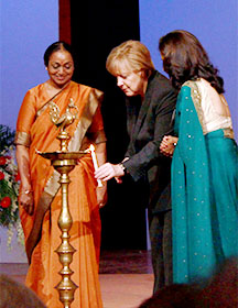 Chancellor Merkel lights an oil lamp