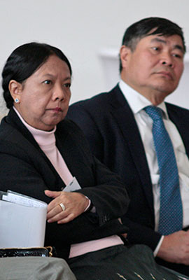 Close-up of two participants listening to a speaker