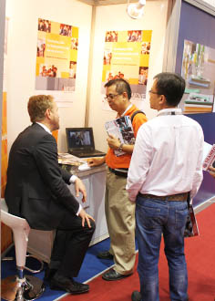 three men talking at the iMOVE information stand