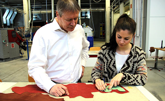 female apprentice as a footwear maker with her trainer