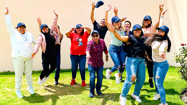 group of young adult Mexicans jump into the air