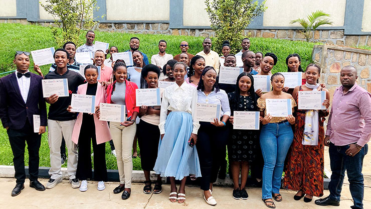 group picture: young women and men showing their certificates