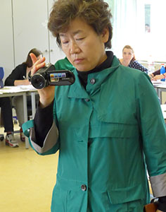 woman from Korea with a video camera in her hand