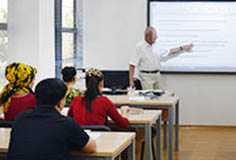 teacher at a blackboard in a classroom with trainees