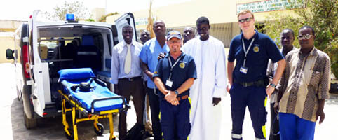 Group photo of trainers and trainees in front of ambulance in Dakar, Senegal