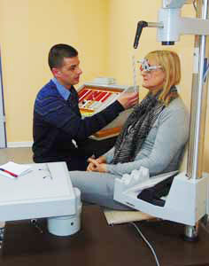 a man examines the eyes of a woman