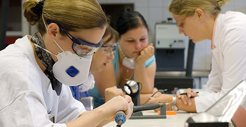 hearing aid acoustician trainees and trainer on the job