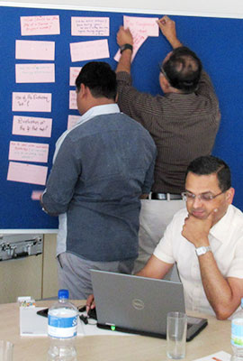 Three Indian men at a training scene