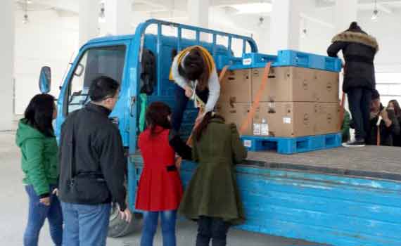 Chinese students attach a load to a truck