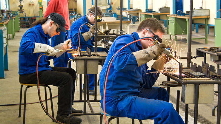young men from Poland practising welding in a training workshop 
