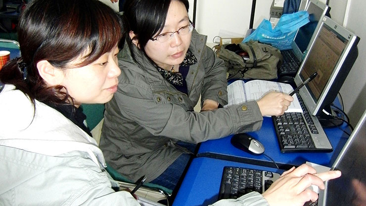 two Chinese women working at computers