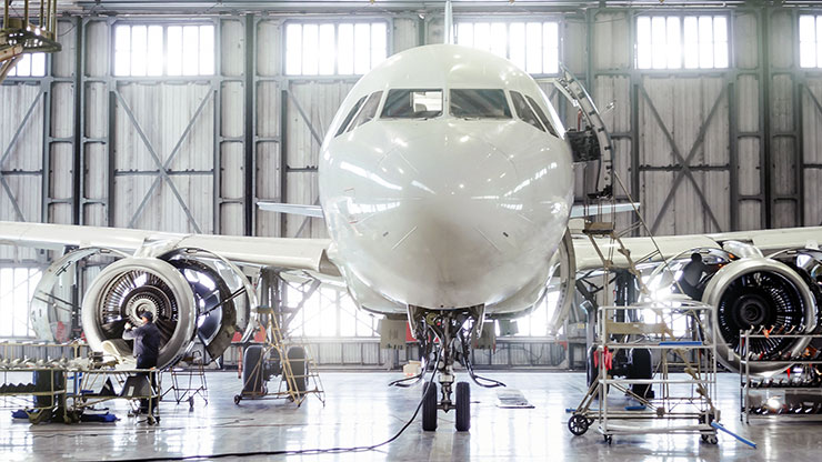 passenger aircraft stands in the hangar for maintenance