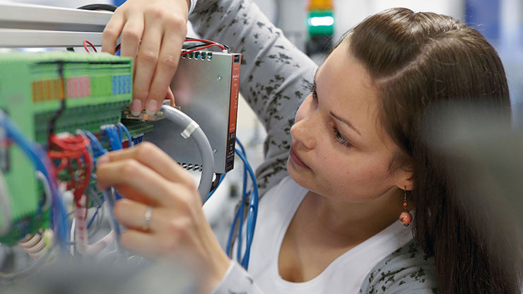 woman working on electrical equipment